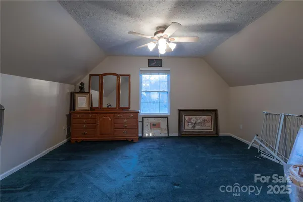 a view of a room with furniture and a chandelier
