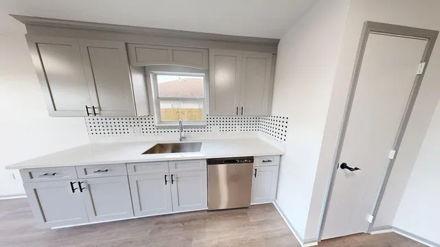 a large kitchen with stainless steel appliances granite countertop a stove and a sink