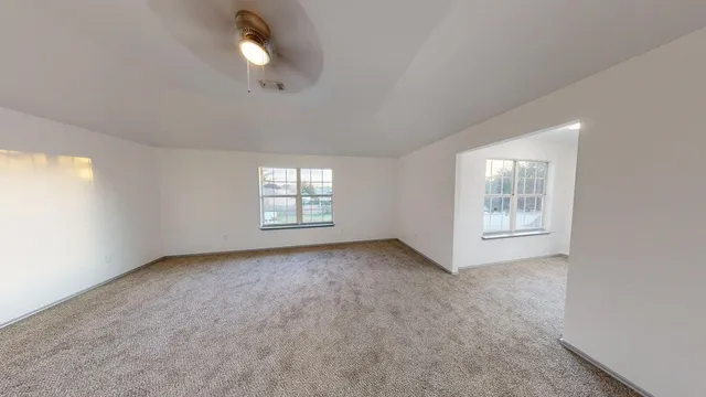 a view of a big room with windows and cabinet