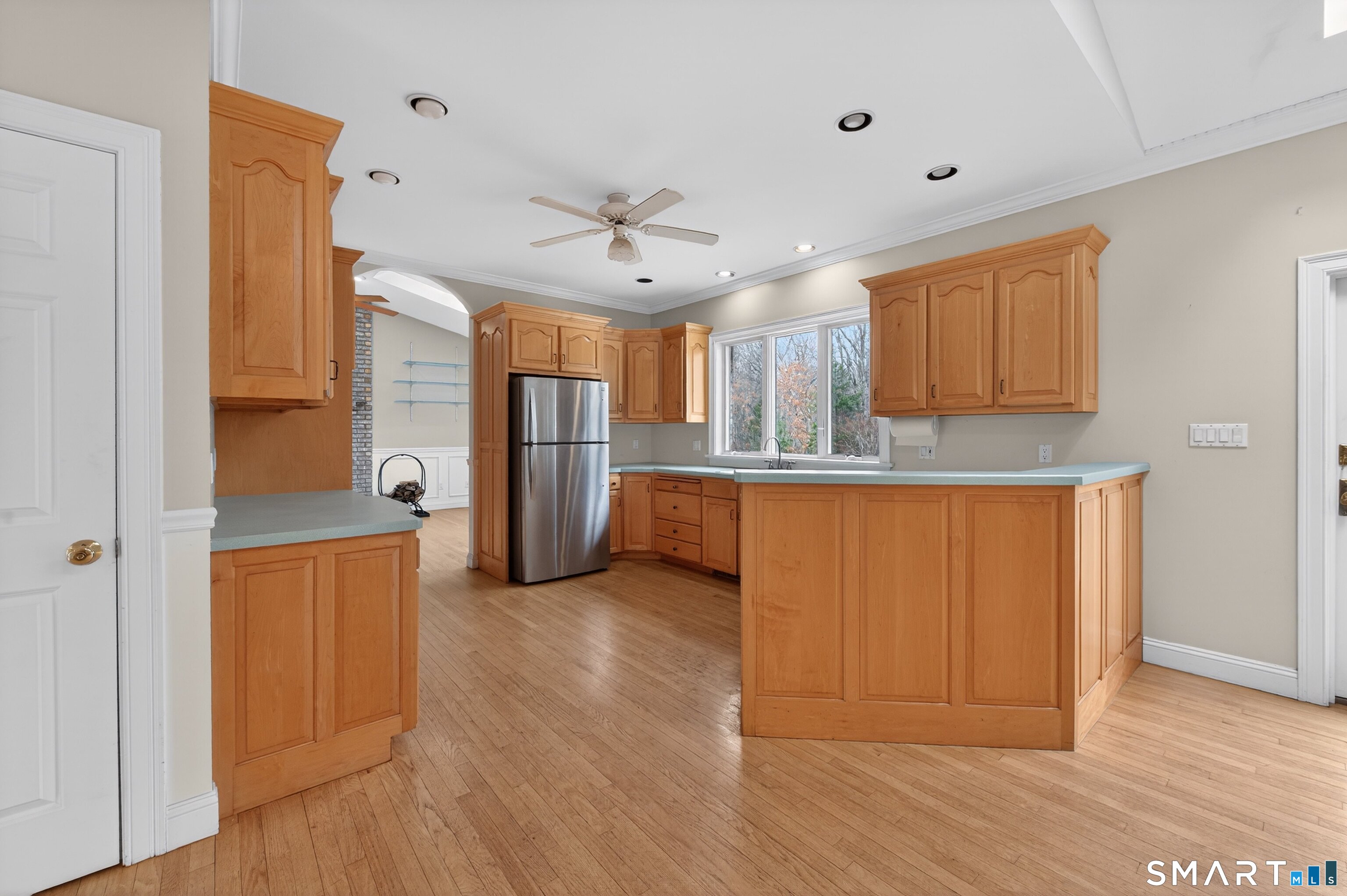 724 Strong Road South Windsor, CT 06074 - Photo 18 of 39 a view of a kitchen with a fridge and wooden floor