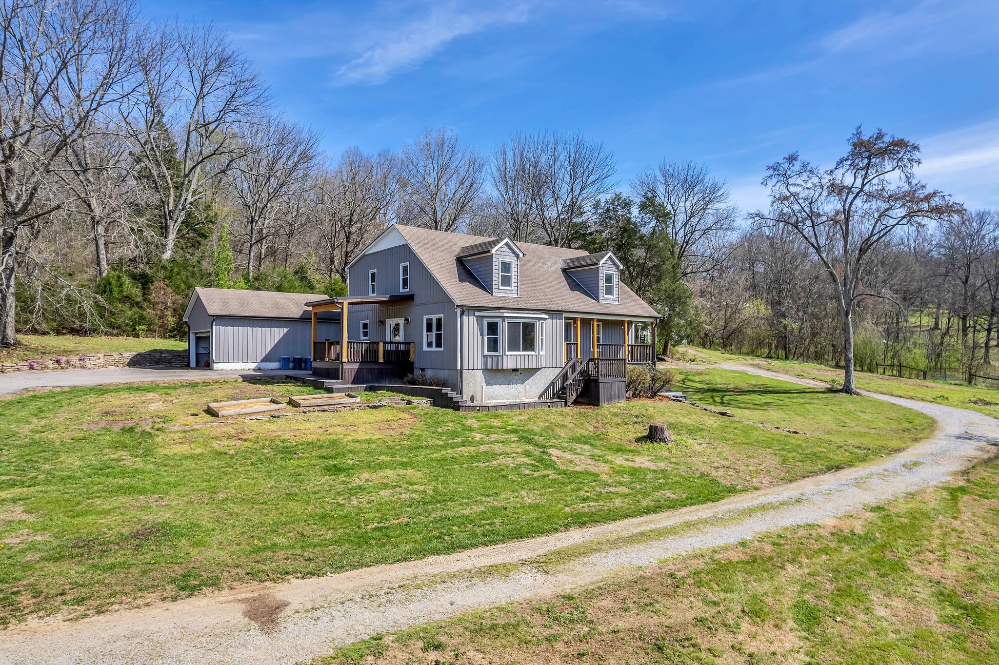 1830 Popes Chapel Road Thompson's Station, TN 37179 - Photo 1 of 53 a front view of a house with a yard table and chairs