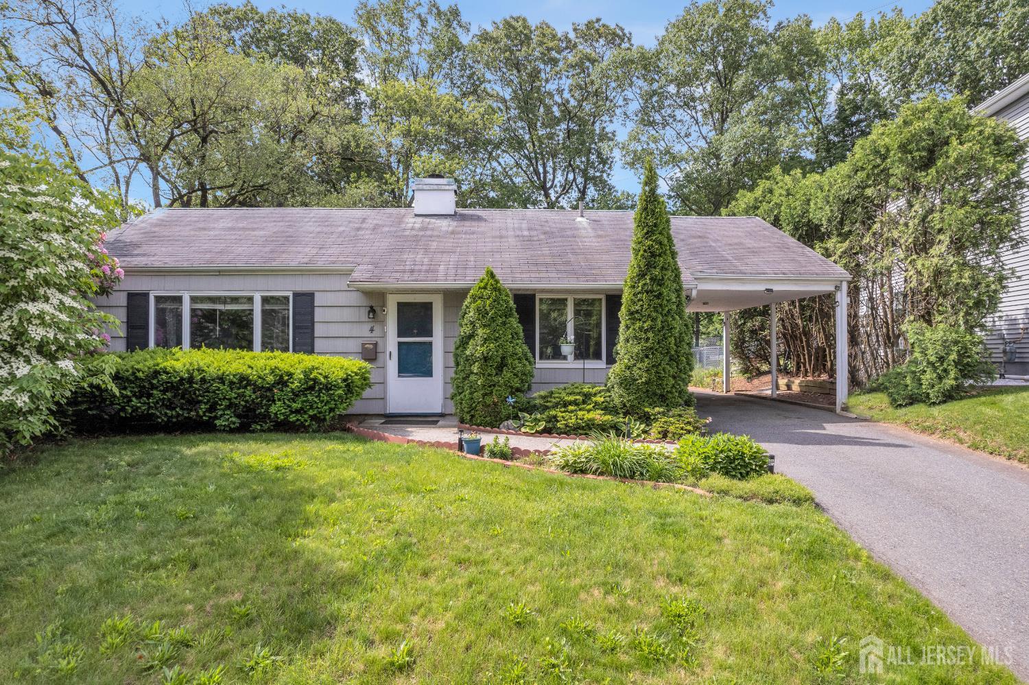 4 Dayton Road Edison, NJ 08817 - Photo 1 of 14 a front view of a house with a garden and trees