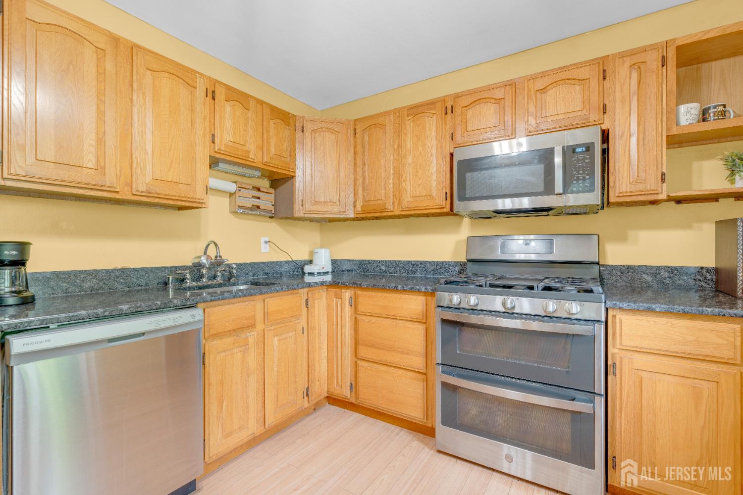 4 Dayton Road Edison, NJ 08817 - Photo 3 of 14 a kitchen with stainless steel appliances granite countertop a stove microwave and cabinets