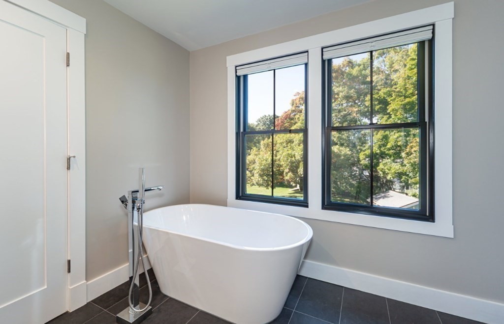 29 Beverly Road Natick, MA 01760 - Photo 14 of 16 a white bath tub sitting in a bathroom next to a window