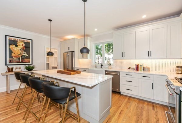 29 Beverly Road Natick, MA 01760 - Photo 5 of 16 a kitchen with stainless steel appliances granite countertop a stove a sink and white cabinets with wooden floor