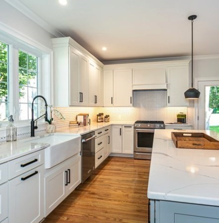 29 Beverly Road Natick, MA 01760 - Photo 6 of 16 a kitchen with a sink stainless steel appliances and white cabinets