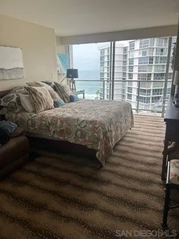 a bedroom with a bed and glass window