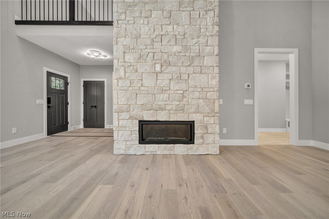 4009 Brainard Road Beachwood, OH 44122 - Photo 13 of 50 living room featuring a stone fireplace and light hardwood floors