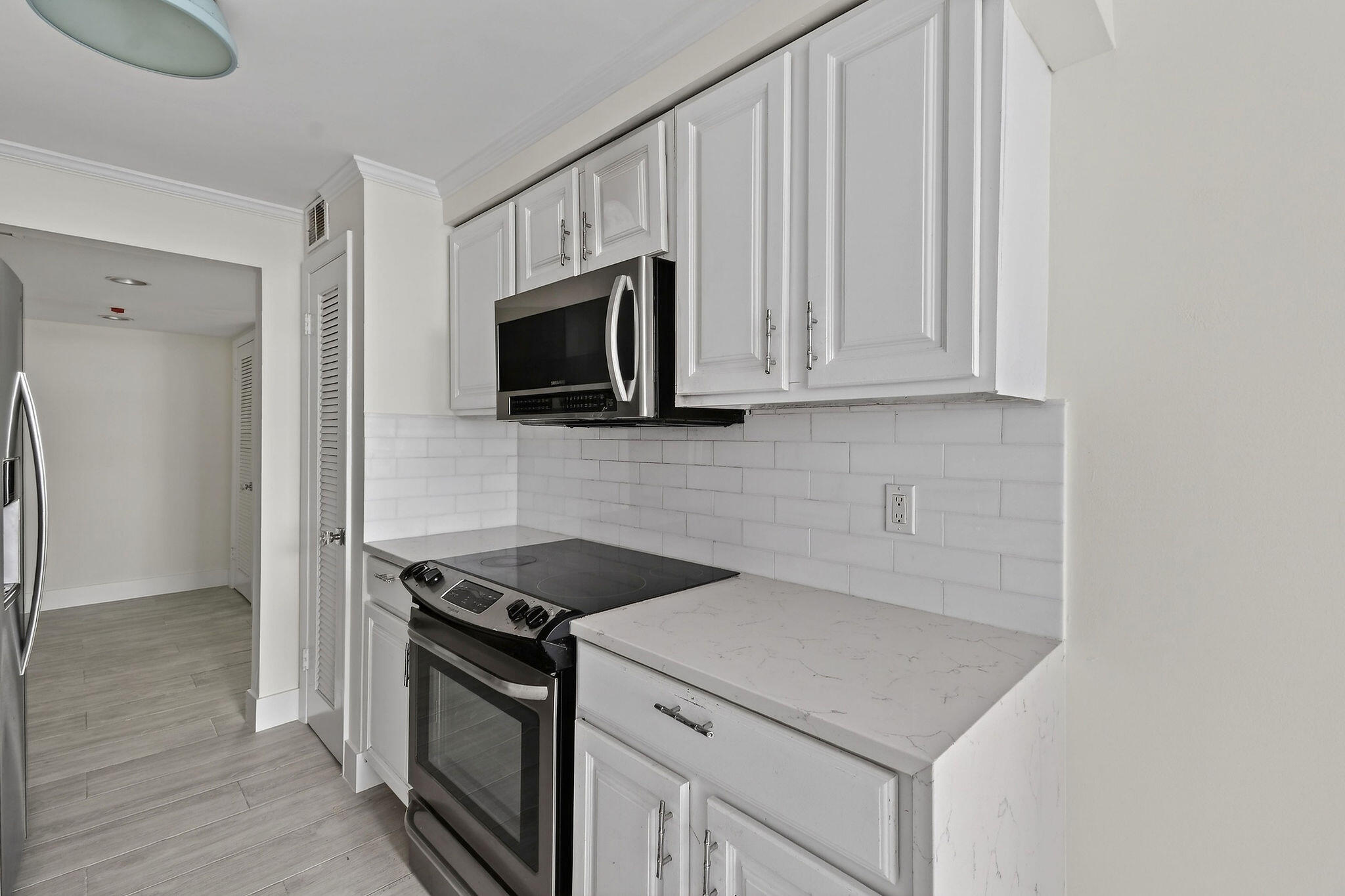 3800 Washington Road, Unit 712 West Palm Beach, FL 33405 - Photo 12 of 48 a kitchen with appliances a sink and cabinets