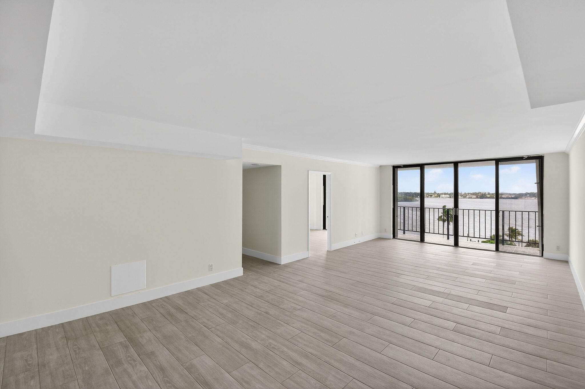3800 Washington Road, Unit 712 West Palm Beach, FL 33405 - Photo 2 of 48 a view of an empty room with wooden floor and a window