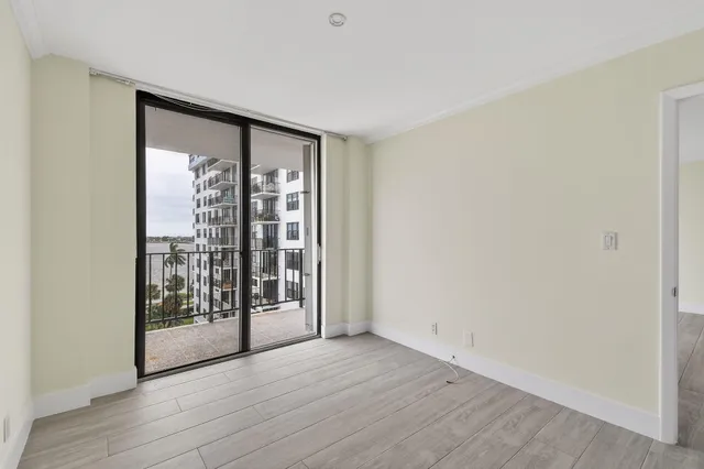 a view of an empty room with glass door