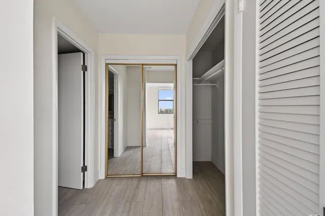 a view of a hallway with wooden floor