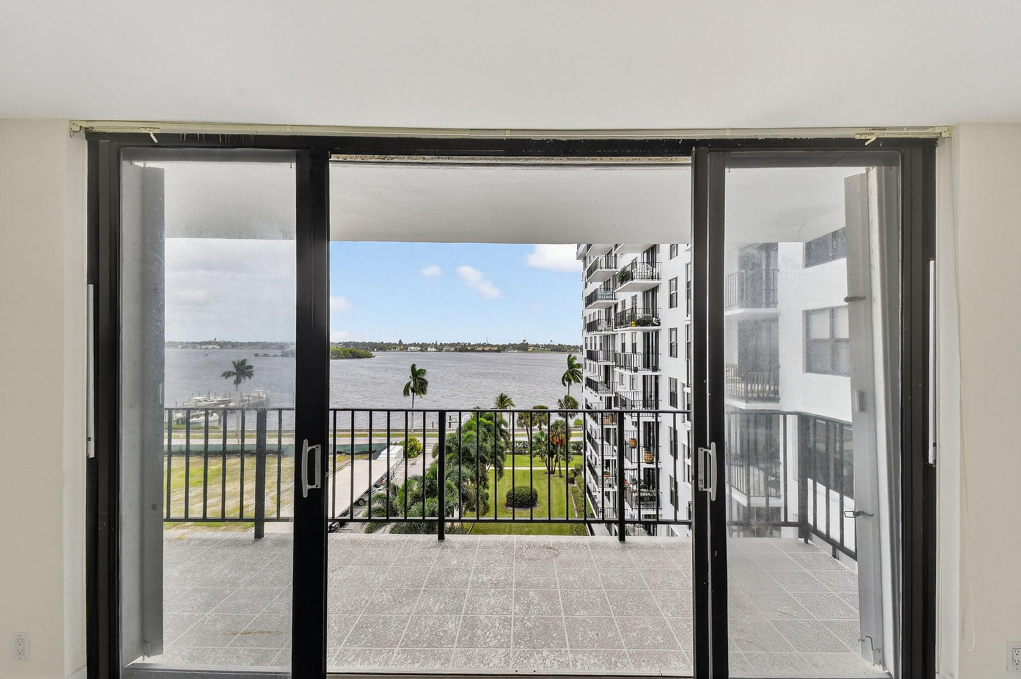 3800 Washington Road, Unit 712 West Palm Beach, FL 33405 - Photo 28 of 48 a view of a glass door with a glass windows