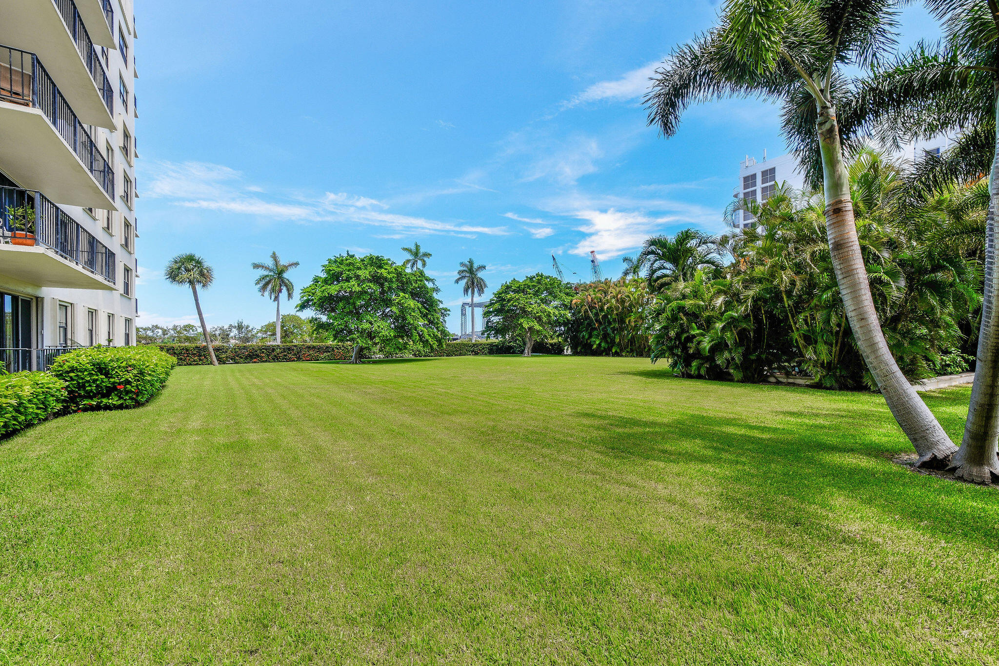 3800 Washington Road, Unit 712 West Palm Beach, FL 33405 - Photo 36 of 48 a view of a garden with a building in the background
