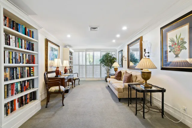 a living room with furniture and a book shelf