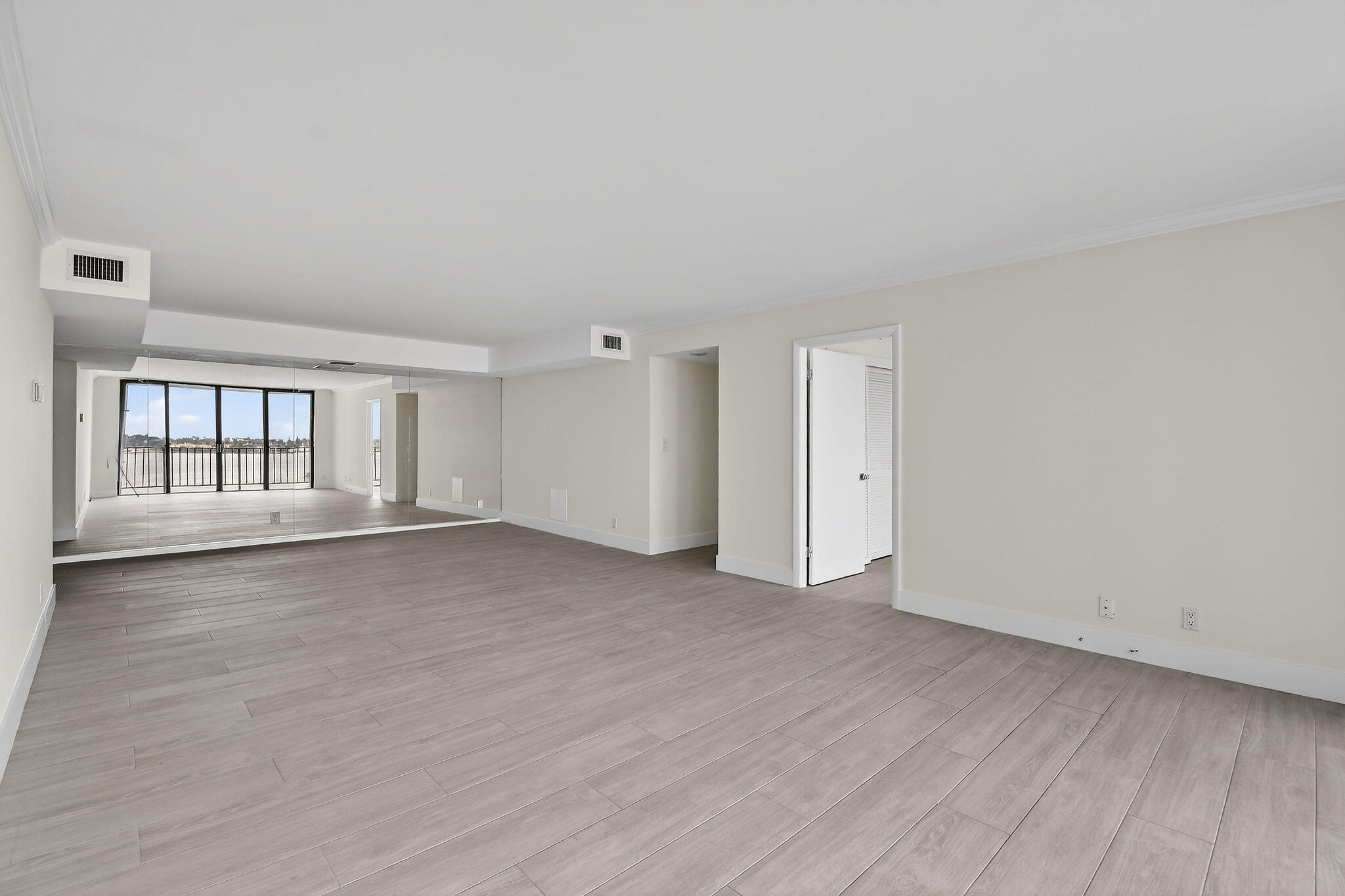 3800 Washington Road, Unit 712 West Palm Beach, FL 33405 - Photo 6 of 48 a view of an empty room with a window and wooden floor