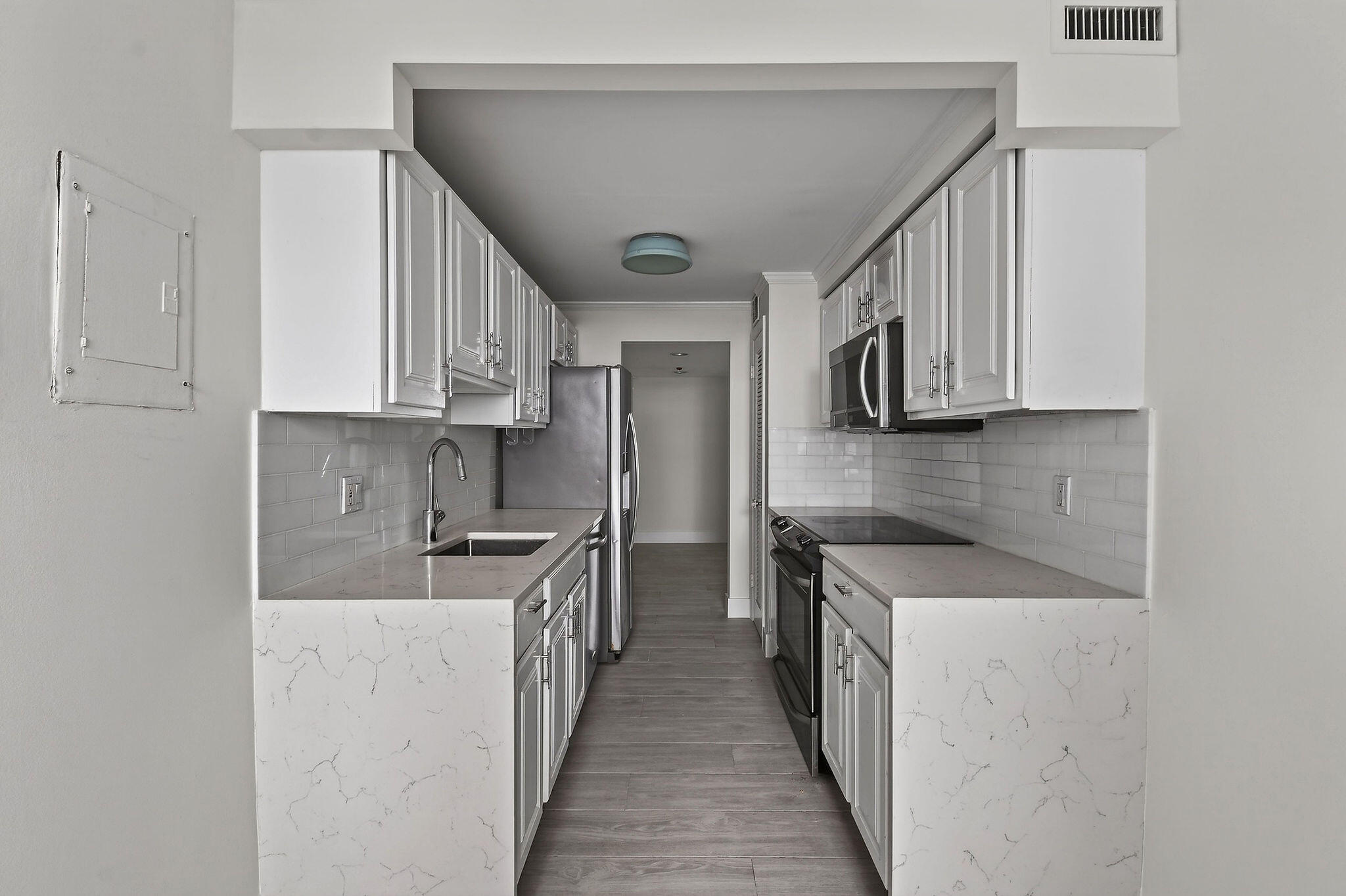 3800 Washington Road, Unit 712 West Palm Beach, FL 33405 - Photo 9 of 48 a kitchen with stainless steel appliances granite countertop a stove a sink and a microwave