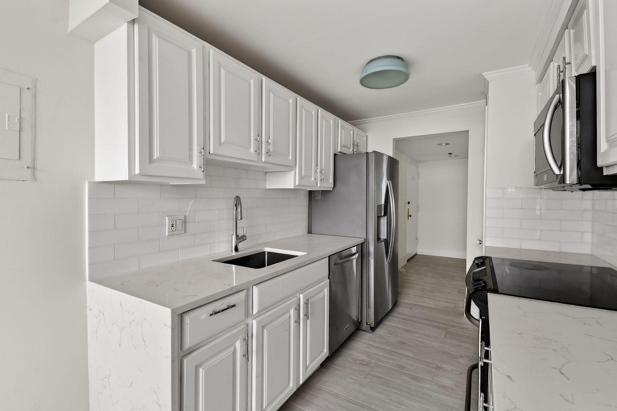3800 Washington Road, Unit 712 West Palm Beach, FL 33405 - Photo 10 of 48 a kitchen with stainless steel appliances granite countertop a sink stove and refrigerator