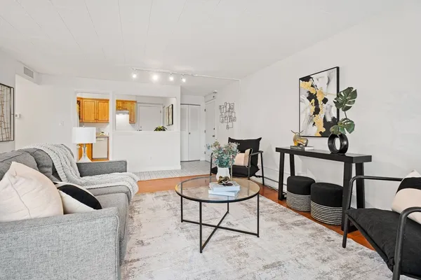 a living room with furniture and wooden floor