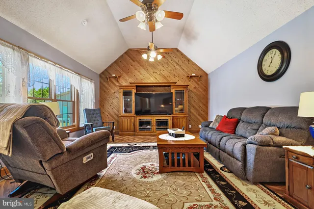 a living room with furniture a rug and a chandelier