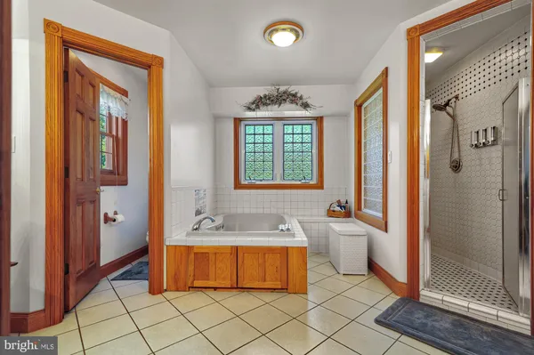 a bathroom with a granite countertop sink a mirror and a shower