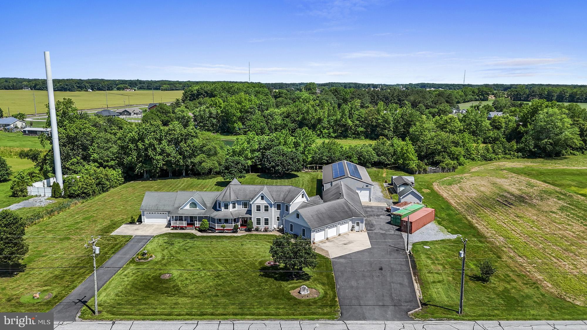 302 East Howard Street Viola, DE 19979 - Photo 54 of 60 a view of a patio with lawn chairs floor to ceiling window and yard