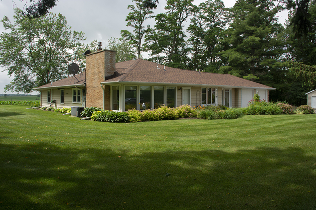 26883 Capp Road Sterling, IL 61081 - Photo 1 of 34 a front view of a house with a yard tree and green space