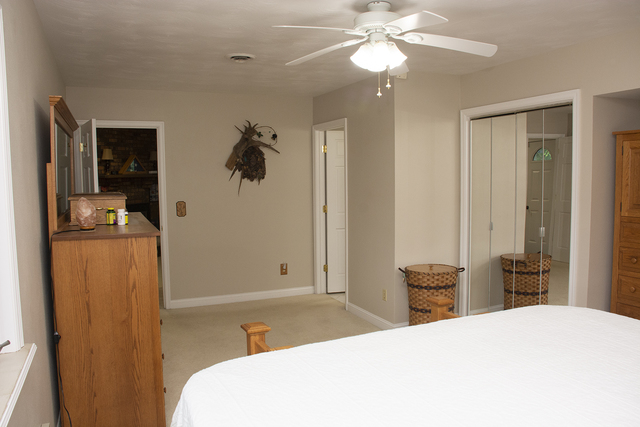 26883 Capp Road Sterling, IL 61081 - Photo 11 of 34 a bedroom with a bed and a chandelier