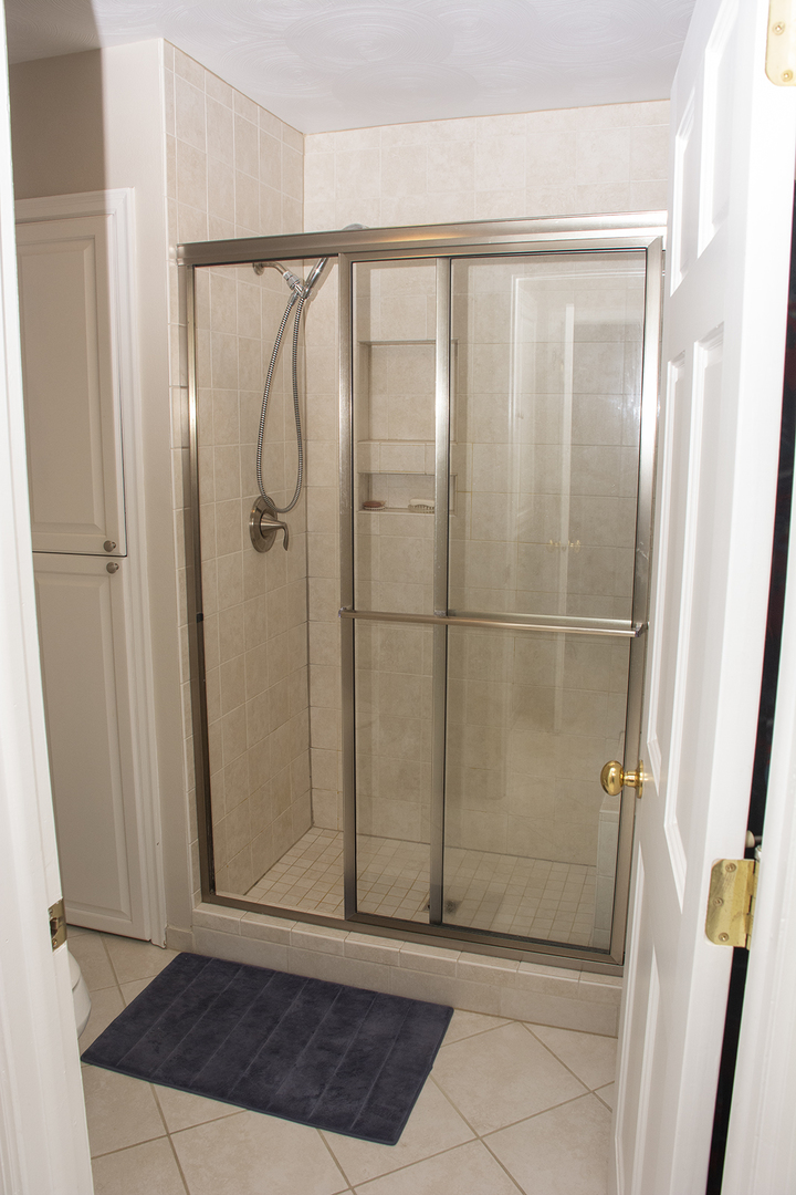 26883 Capp Road Sterling, IL 61081 - Photo 12 of 34 a bathroom with a glass door shower