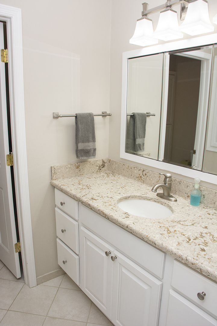26883 Capp Road Sterling, IL 61081 - Photo 13 of 34 a bathroom with a granite countertop sink and a mirror