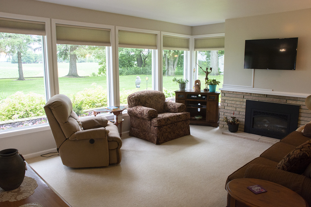 26883 Capp Road Sterling, IL 61081 - Photo 15 of 34 a living room with furniture a flat screen tv and a large window