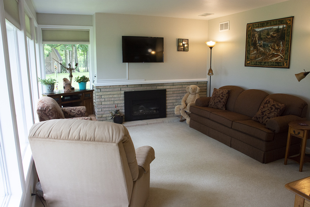 26883 Capp Road Sterling, IL 61081 - Photo 16 of 34 a living room with furniture a flat screen tv and a fireplace