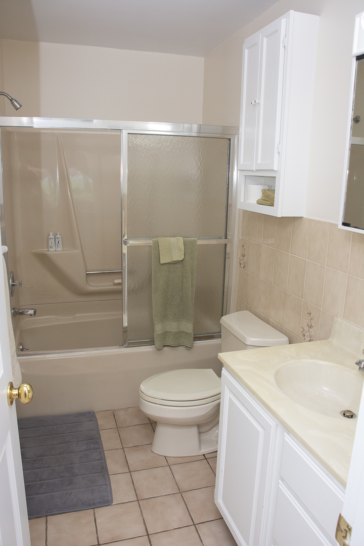 26883 Capp Road Sterling, IL 61081 - Photo 19 of 34 a bathroom with a sink a toilet and shower