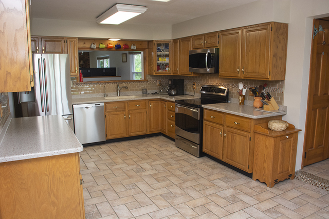 26883 Capp Road Sterling, IL 61081 - Photo 4 of 34 a kitchen with stainless steel appliances granite countertop a stove microwave and sink