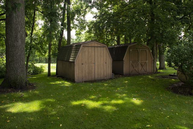 26883 Capp Road Sterling, IL 61081 - Photo 32 of 34 a view of backyard with large trees and wooden fence