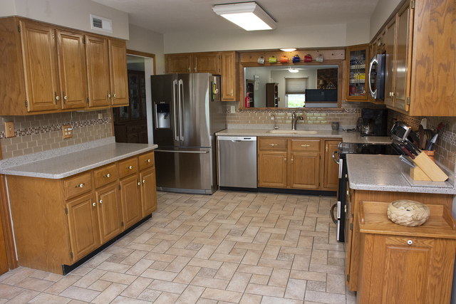 26883 Capp Road Sterling, IL 61081 - Photo 5 of 34 a kitchen with stainless steel appliances granite countertop a sink stove and refrigerator