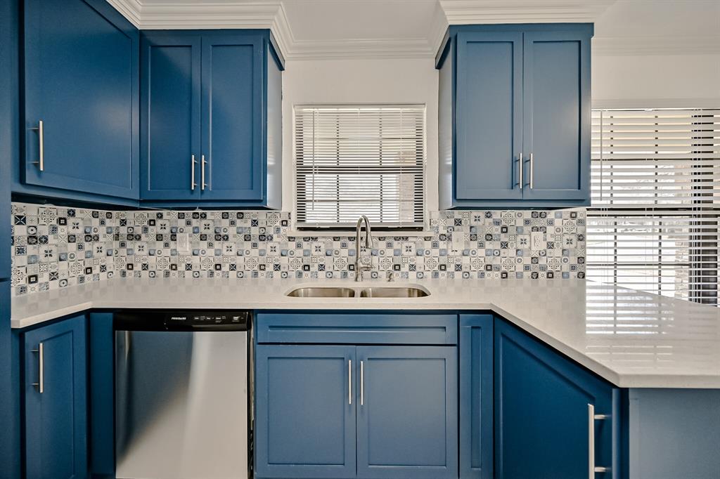 a kitchen with granite countertop cabinets sink and window