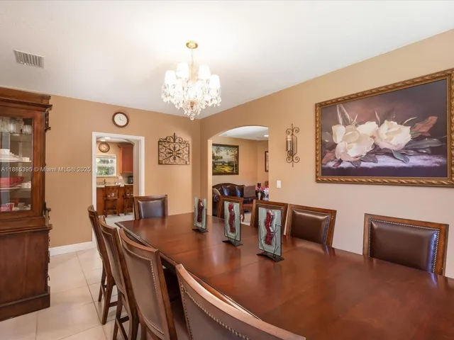 a kitchen with stainless steel appliances granite countertop a refrigerator a sink dishwasher a stove with wooden cabinets and a granite counter top