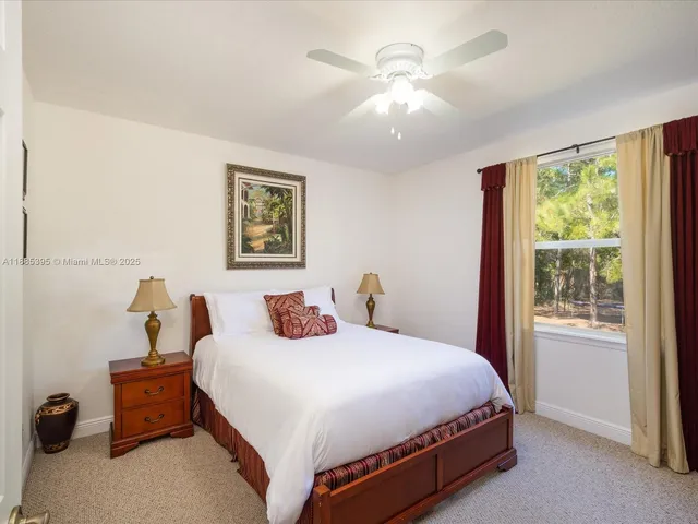 a bedroom with a bed wooden floor and window