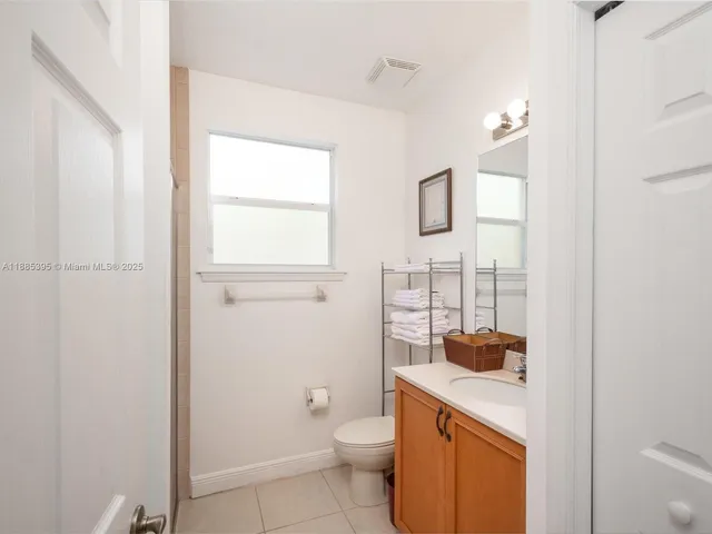 a view of backyard with large trees and plants