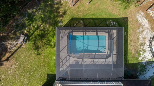 a view of a patio with a table and chairs under an umbrella