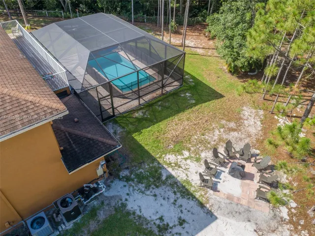 a view of outdoor space with seating area and trees around