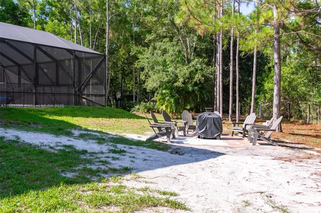 a view of outdoor space with sliding house and trees in the background