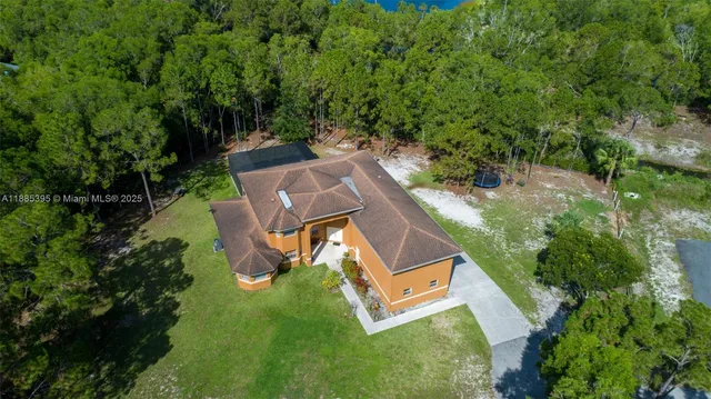 an aerial view of a house with a yard