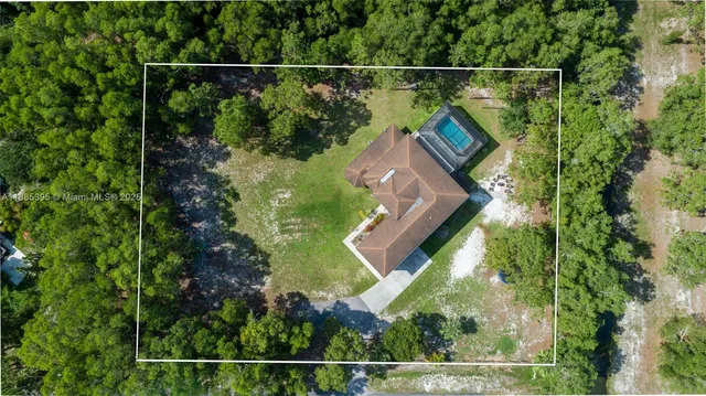 a view of a backyard with a swimming pool