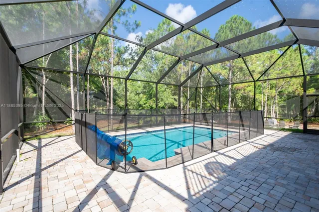 a living room with furniture ceiling fan and a large window