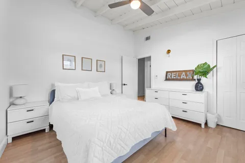 a spacious bedroom with a bed and a couch