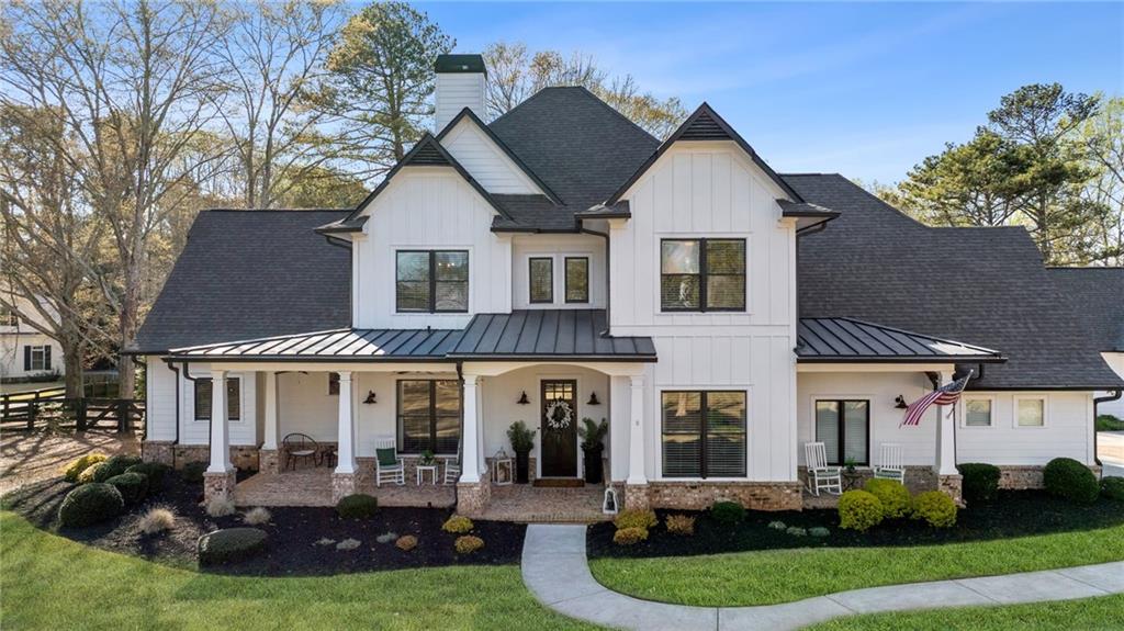 15290 Freemanville Road Milton, GA 30004 - Photo 1 of 1 a front view of a house with garden and trees