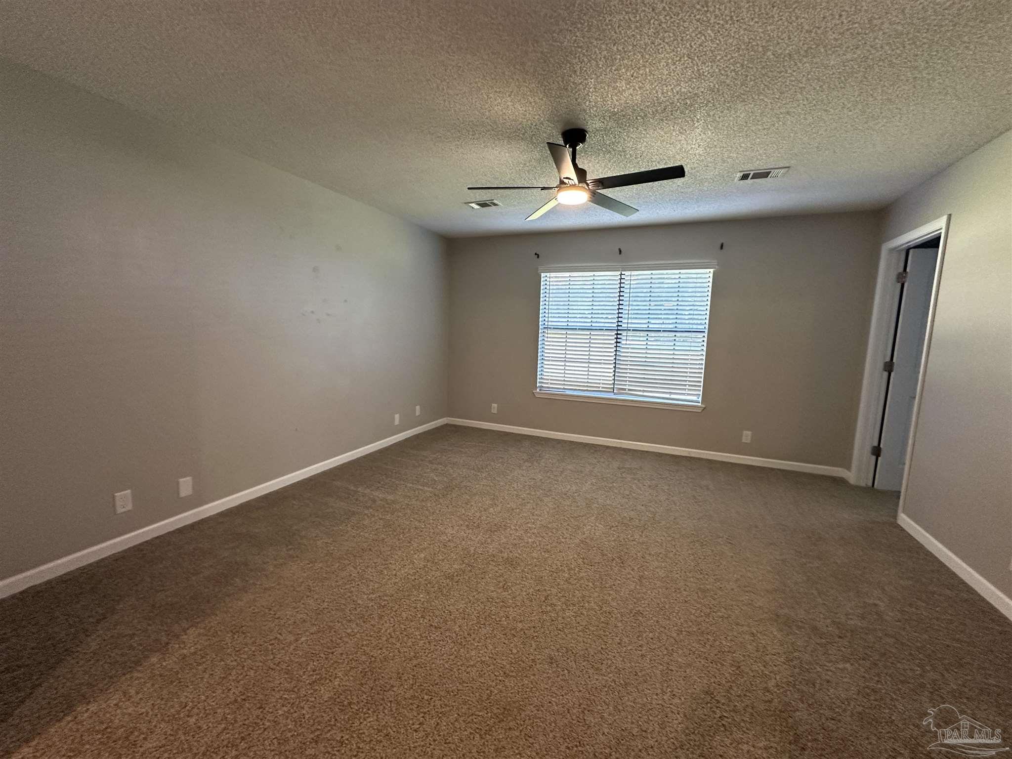 7720 Jansen Road Pensacola, FL 32526 - Photo 11 of 30 an empty room with a window and a ceiling fan