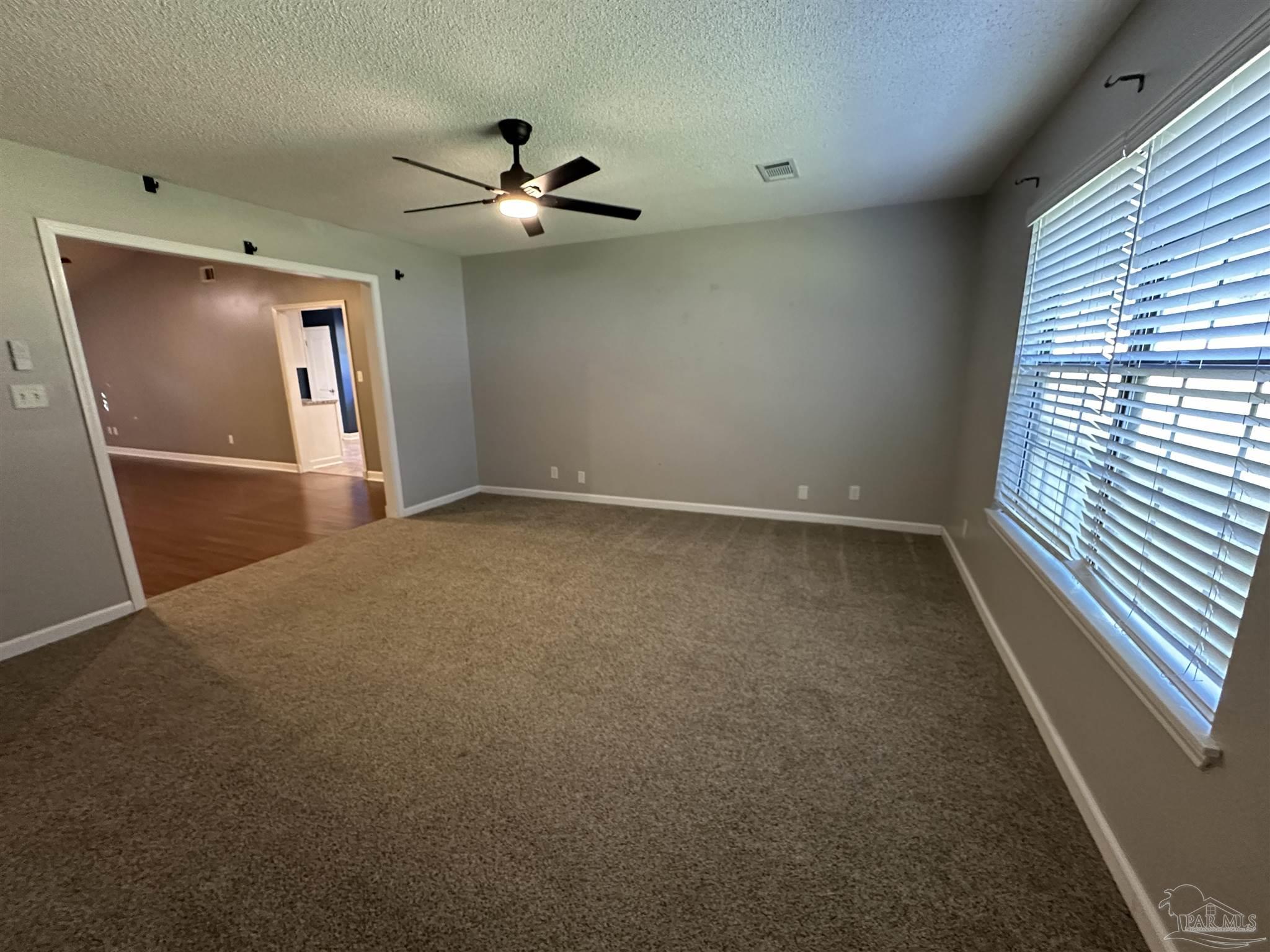 7720 Jansen Road Pensacola, FL 32526 - Photo 12 of 30 an empty room with windows and fan